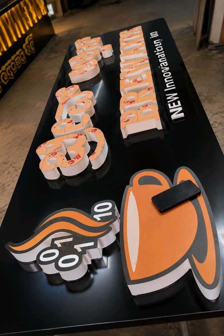 Fabricated 3D acrylic letters and logo mounted on a black signage tray