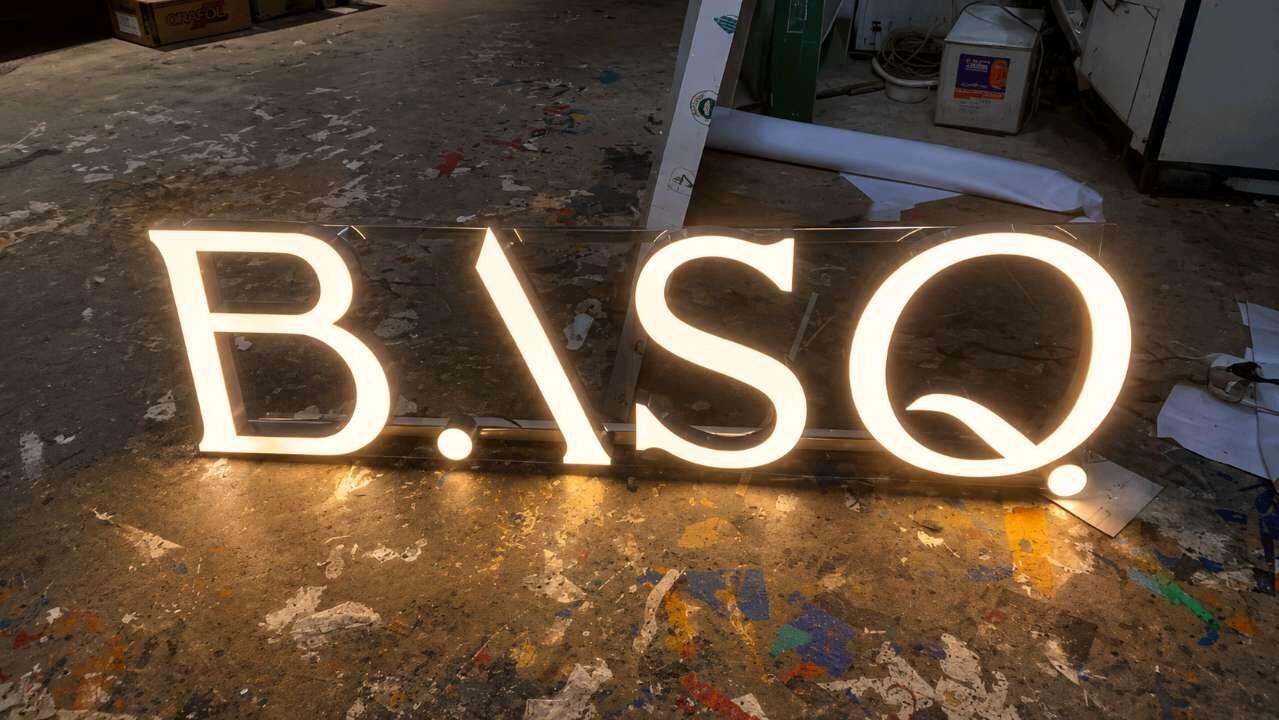 Backlit acrylic letters glowing during installation