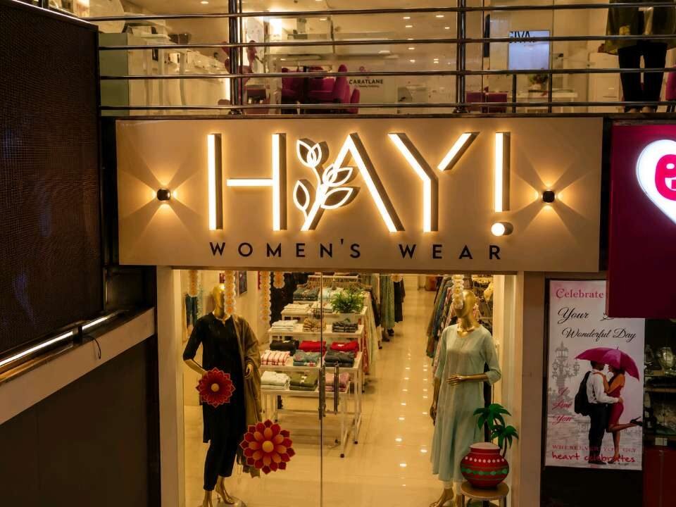 Illuminated store entrance signage for a women's wear showroom