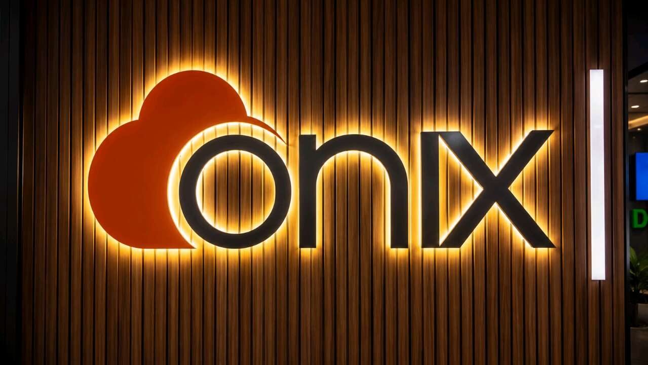 Backlit 3D letters and logo mounted on a wooden slat wall