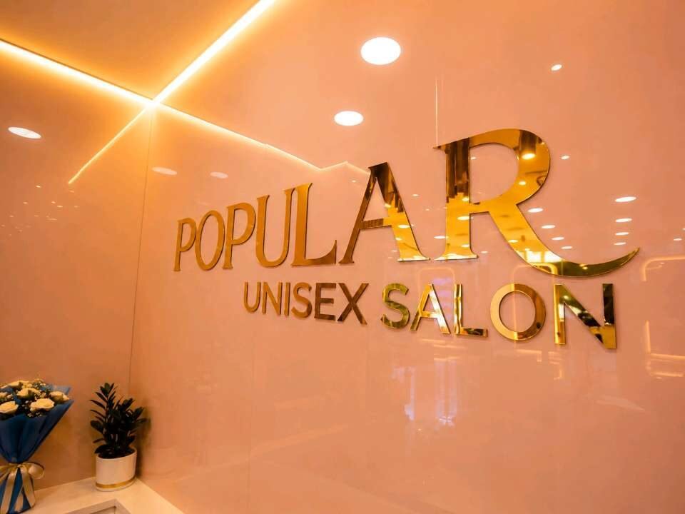 Gold finish 3D letters mounted on a salon interior wall