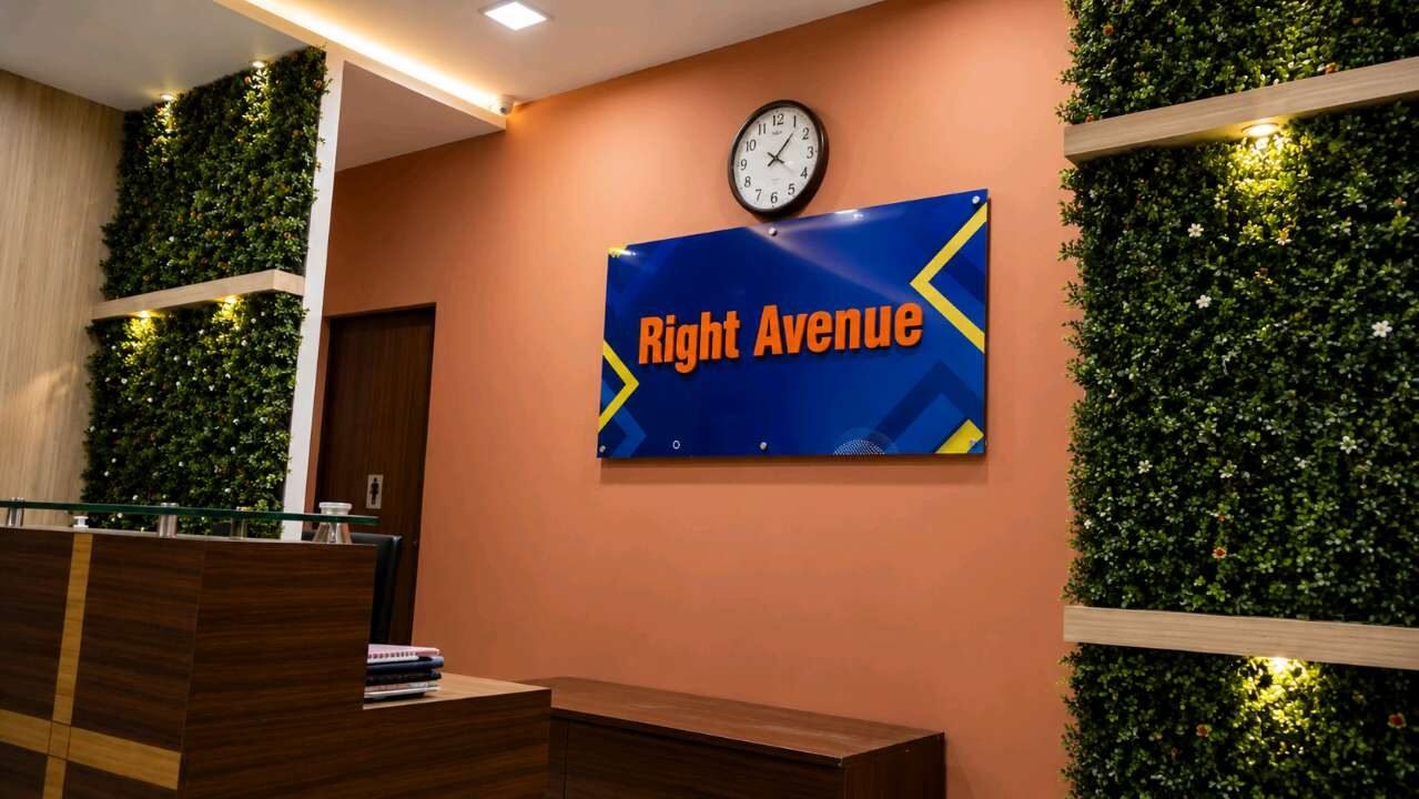 Wall-mounted video display in a reception area with green wall backdrop