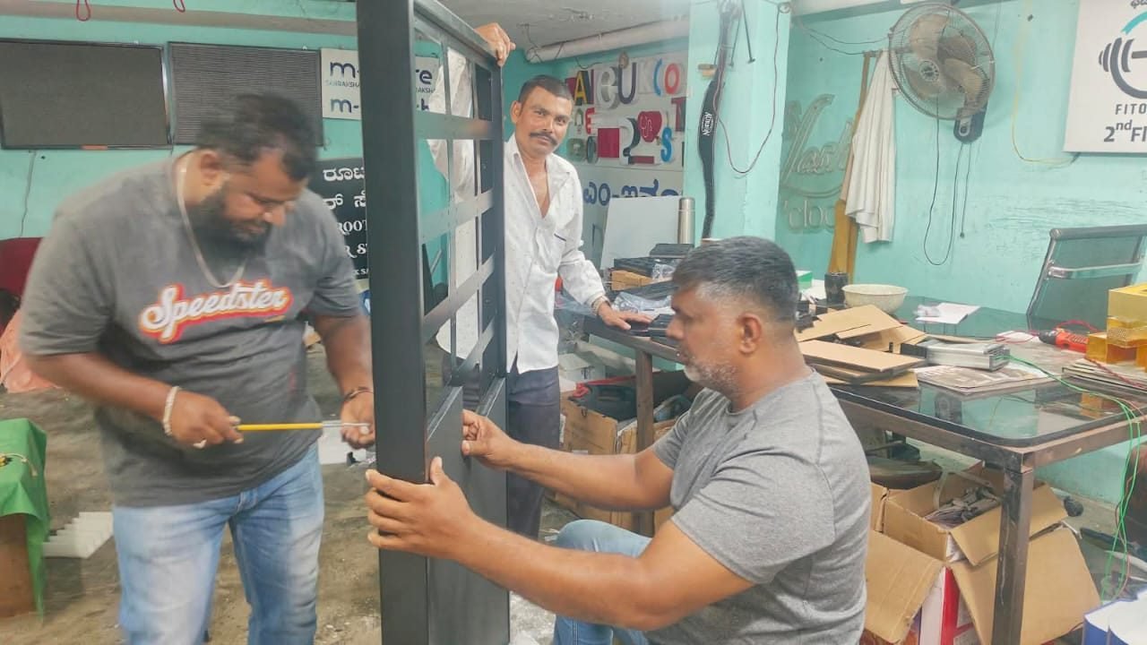 3D SIGN team assembling a steel signage frame in the fabrication workshop