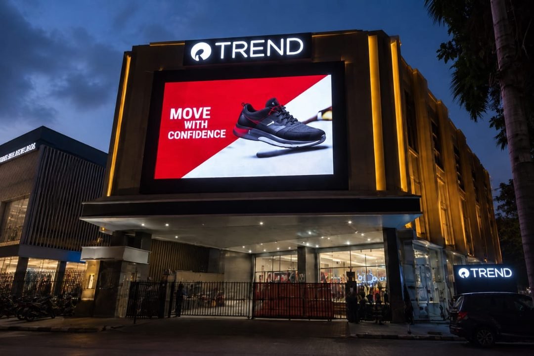 Large format LED video wall installed on a retail store facade, showing a footwear ad